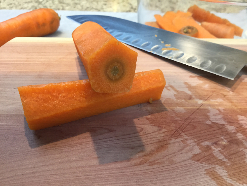 Cut length-wise down the side of the carrot to make 5 sides.