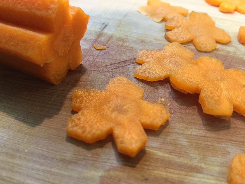 Cut carrot into thin slices to create flowers.